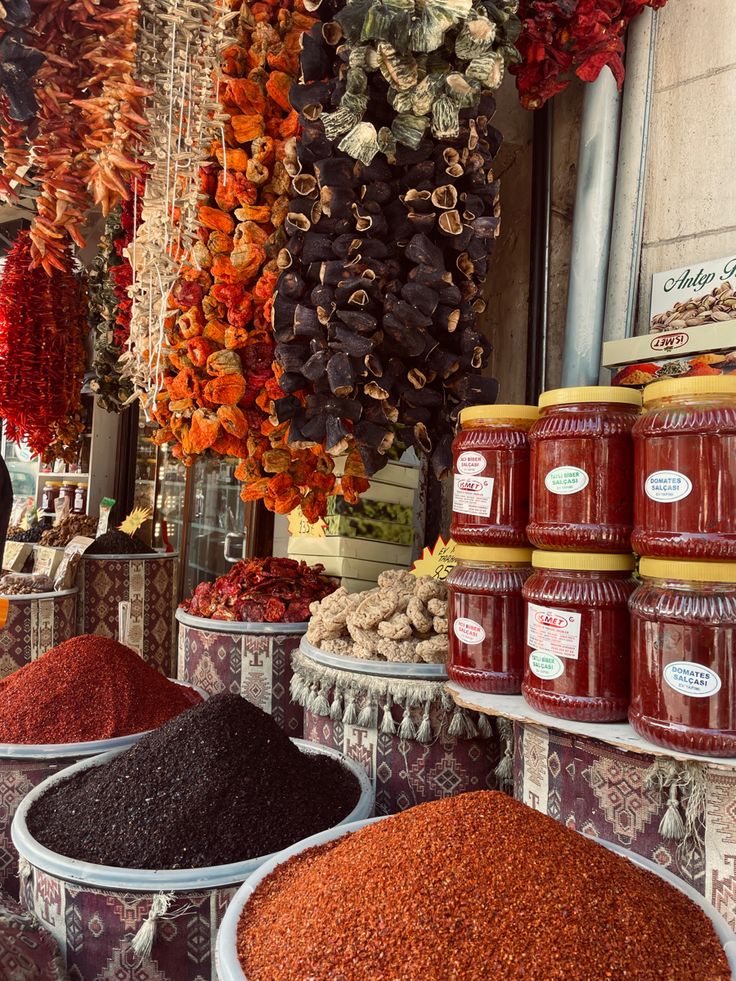 various spices are displayed in buckets on display