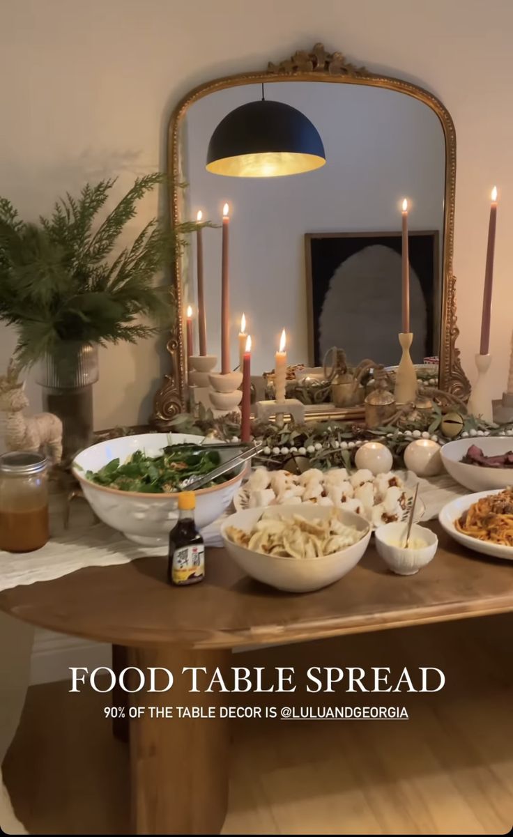 a table filled with lots of food and candles