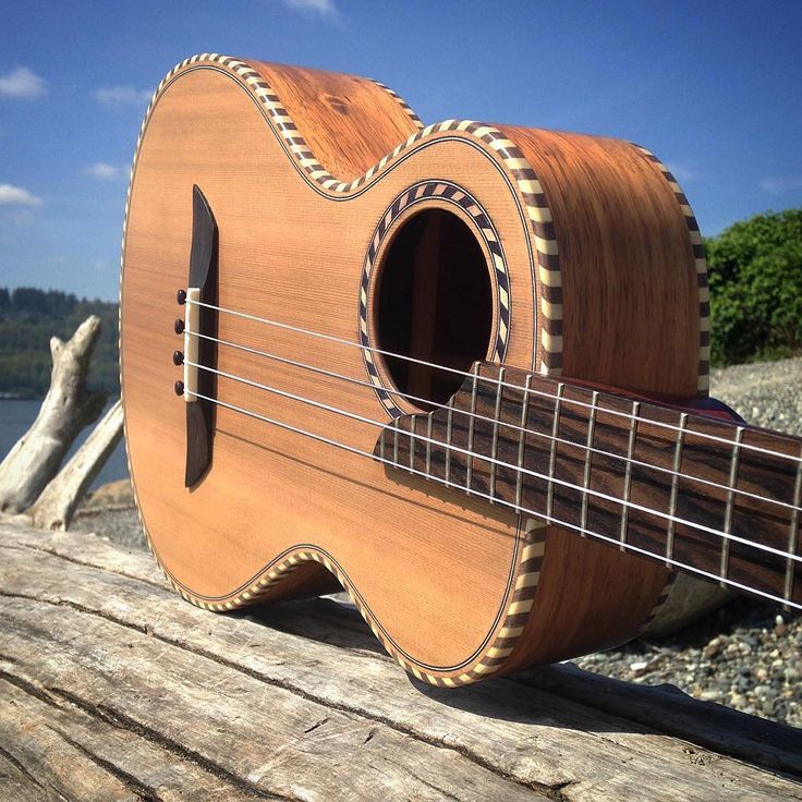 a ukulele sitting on top of a wooden dock