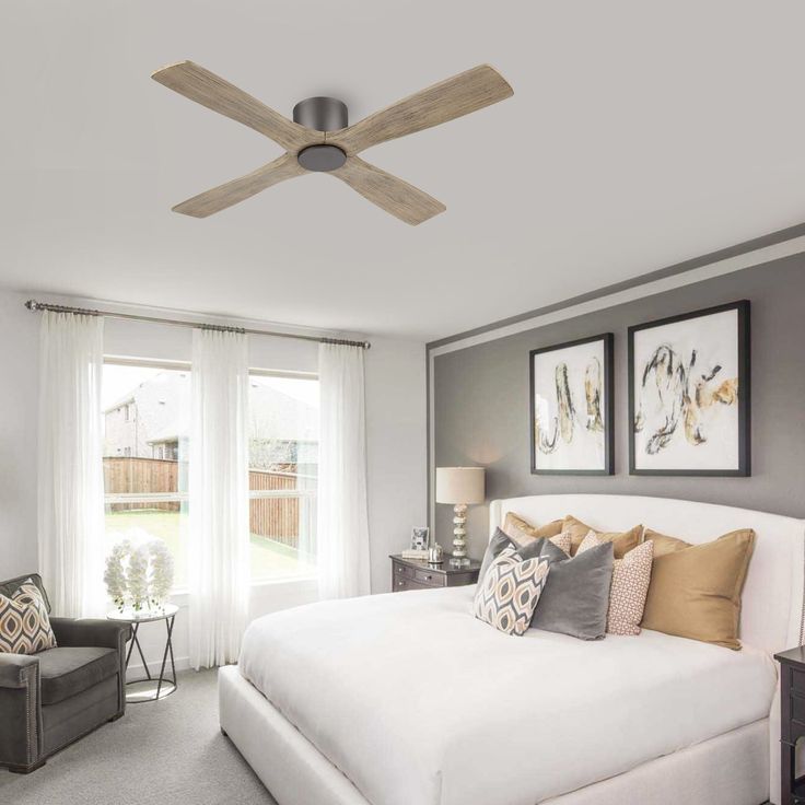 a bedroom with a ceiling fan and white bed