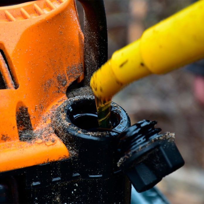 an orange and black fire hydrant with a yellow hose connected to it