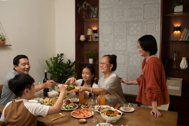 a group of people sitting around a table eating food