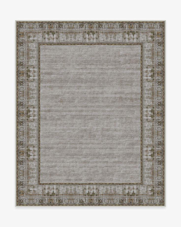 a rug with an ornate border in grey and beige colors, on a white background