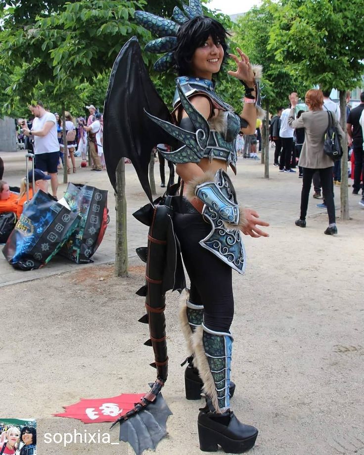 a woman dressed in costume standing on the street