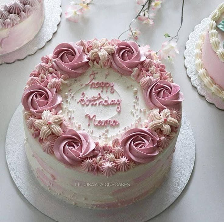 a birthday cake with pink frosting and flowers