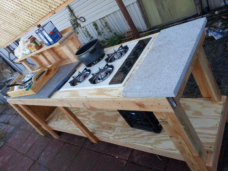 an outdoor kitchen made out of wood and granite