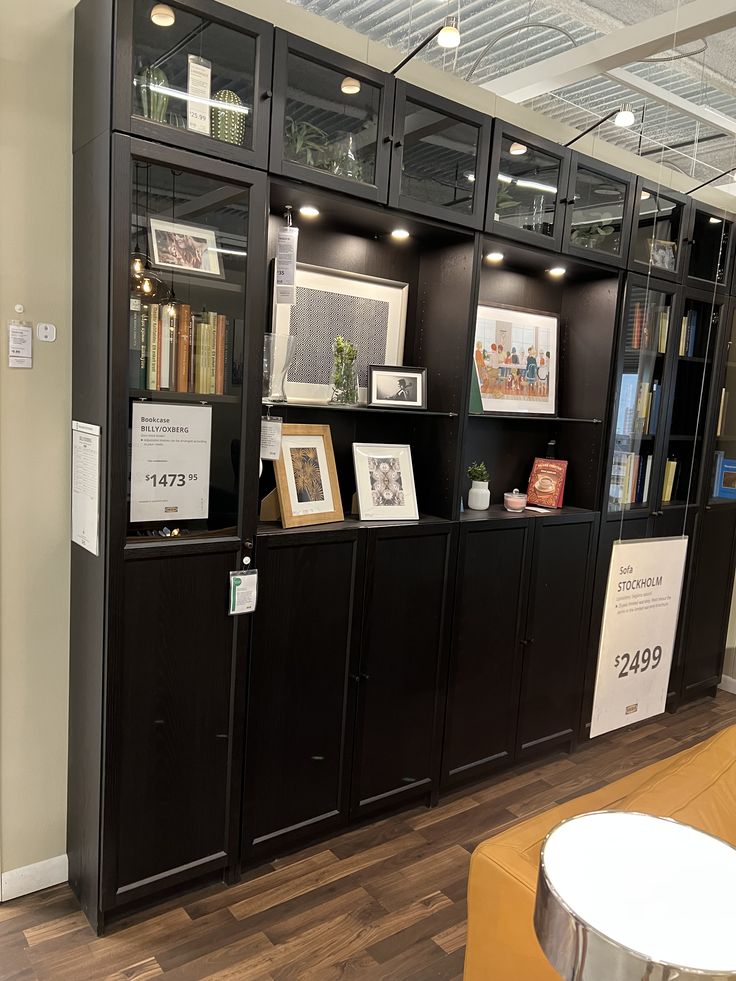 a book shelf with books and pictures on it