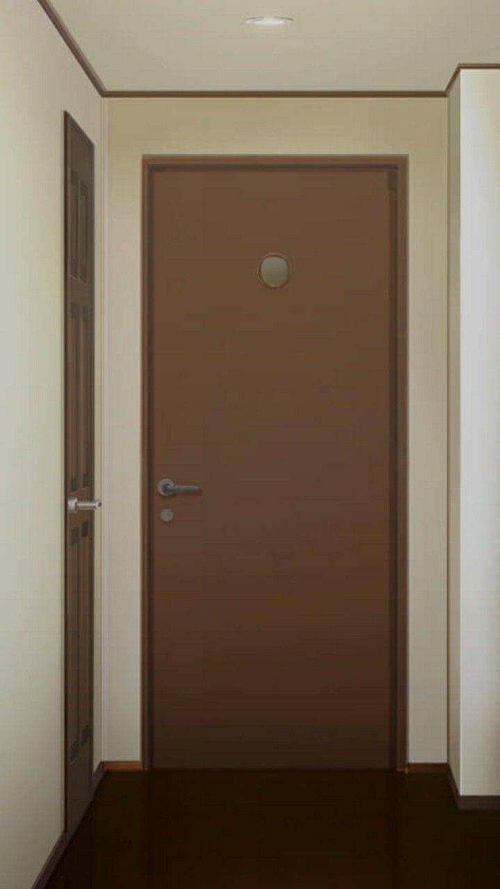 an empty hallway with a brown door and white walls on the right side is a light fixture