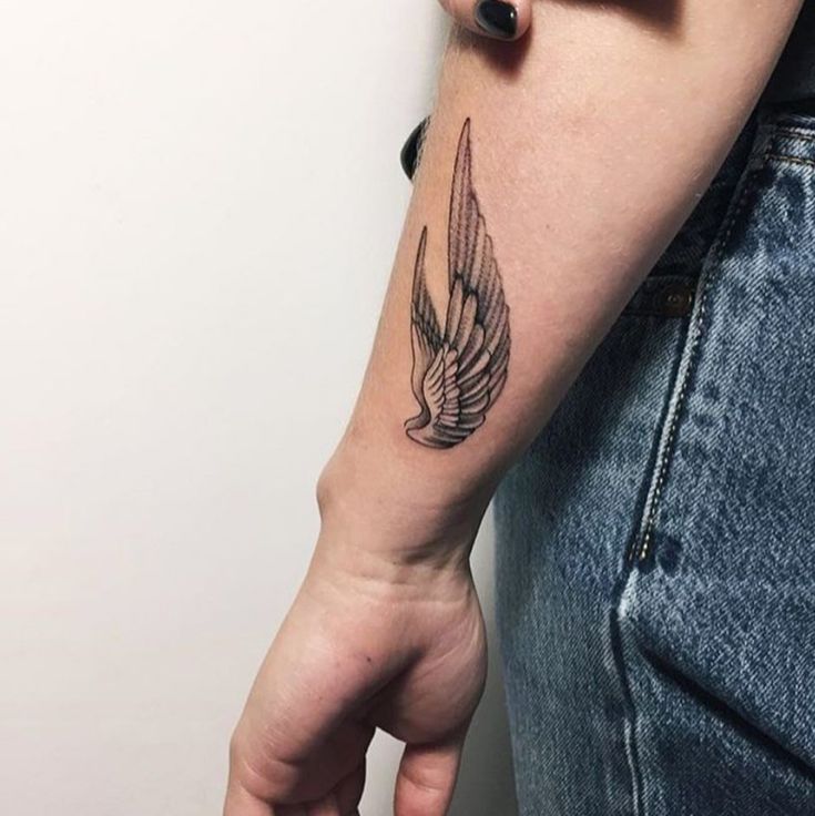 a person with a bird tattoo on their arm