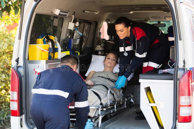 a woman is being loaded into the back of an ambulance