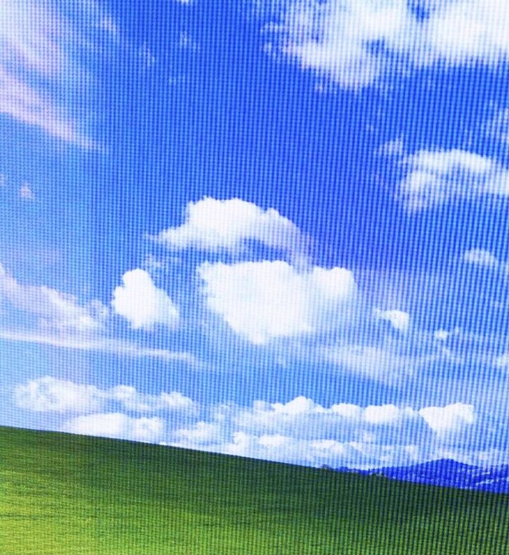 an image of the sky with clouds and grass