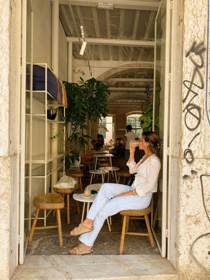 a woman sitting on a chair in an open doorway