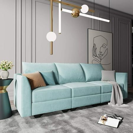 a living room with a blue couch and two lamps