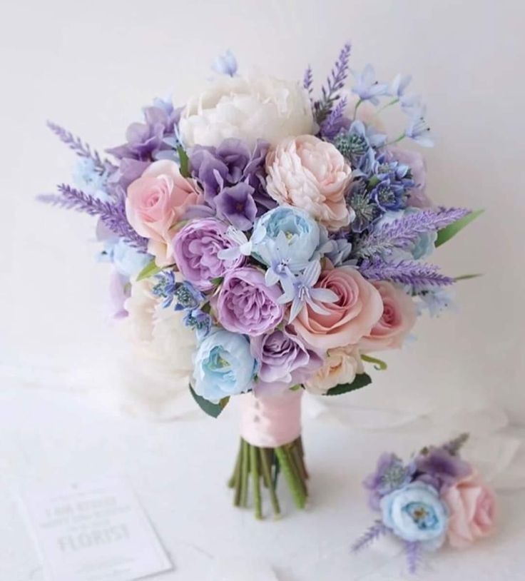 a bridal bouquet with purple and white flowers