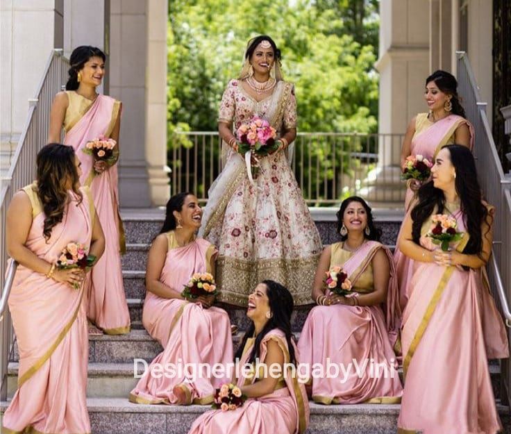 a bride and her bridal party sitting on the steps