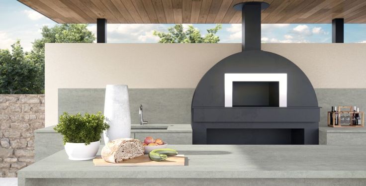 an outdoor kitchen with a wood burning stove