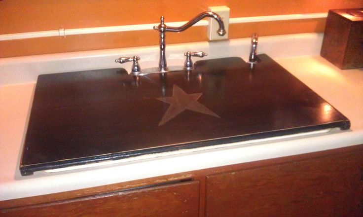 a kitchen sink with two faucets in it