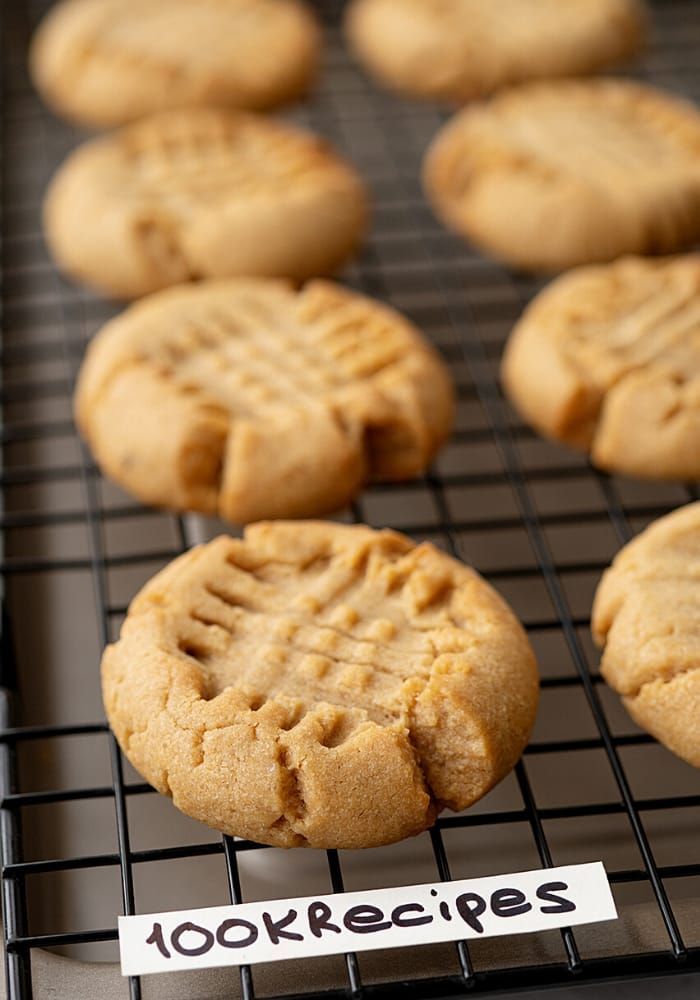 cookies cooling on a wire rack with a note that reads 100krecipes