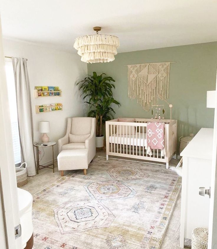 a baby's room with a crib, chair, rug and potted plant