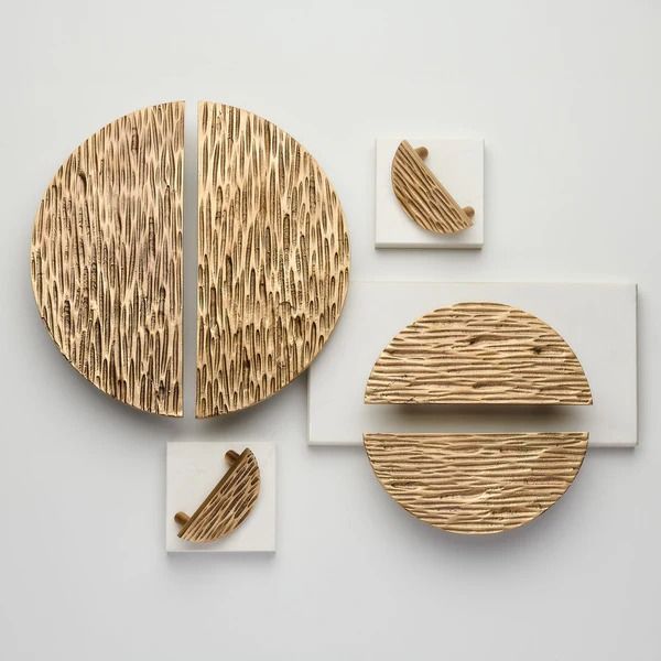 three pieces of art made out of wood and white paper on top of each other