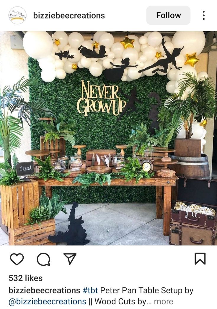 a table that has some plants on it and balloons hanging from the ceiling above it