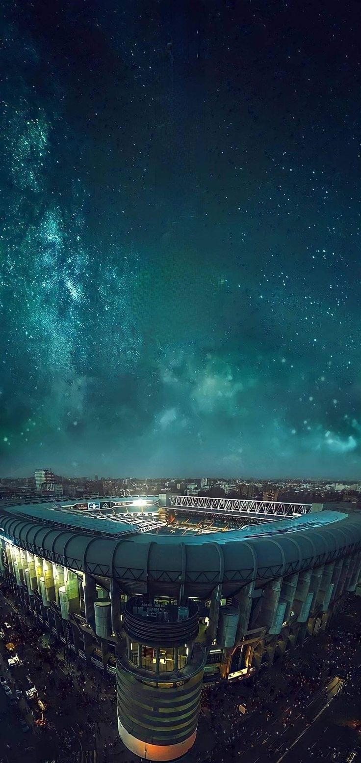 an aerial view of a stadium at night with the stars in the sky above it