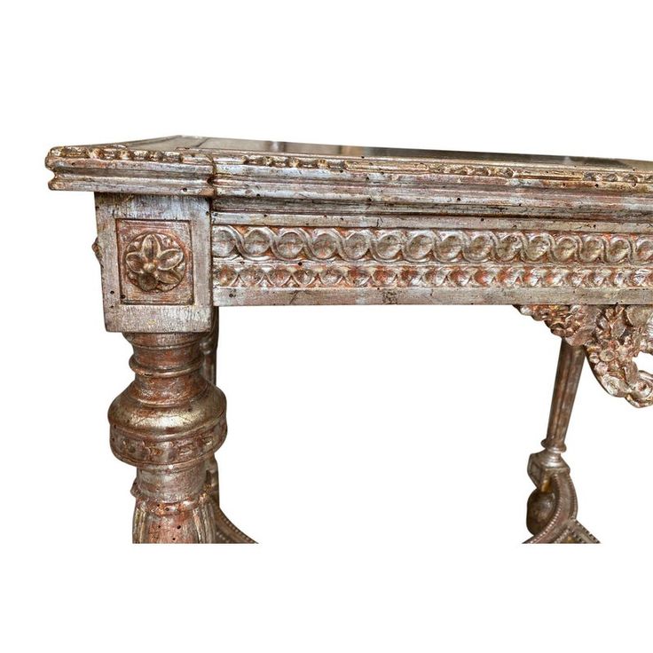 an old wooden table with ornate carvings on the top and bottom, against a white background