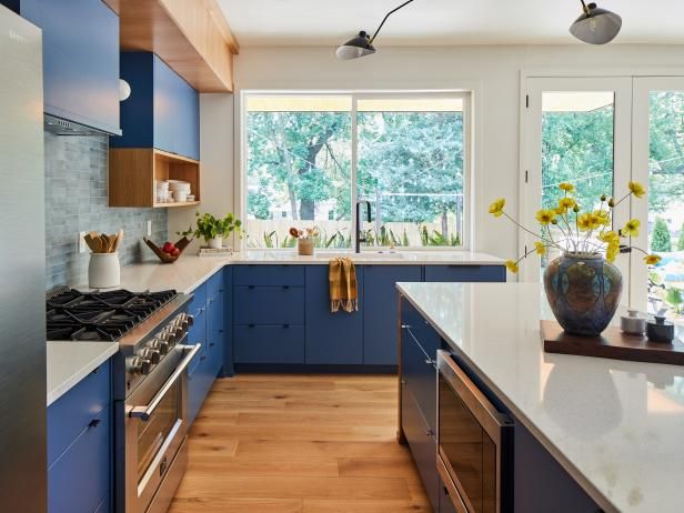 a kitchen with blue cabinets and white counter tops is seen in this image from the inside