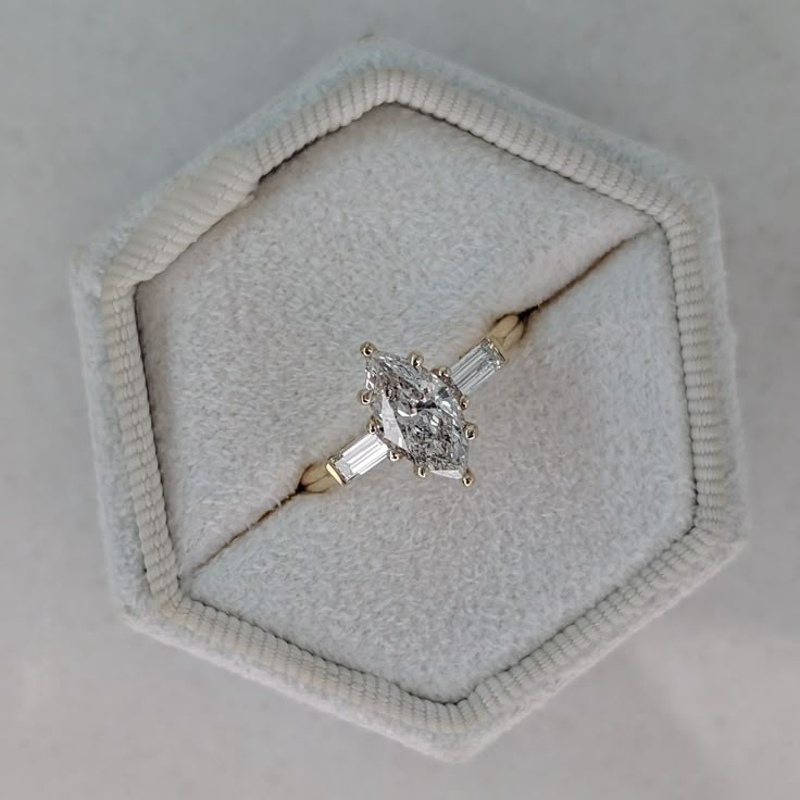 an engagement ring is sitting in a box