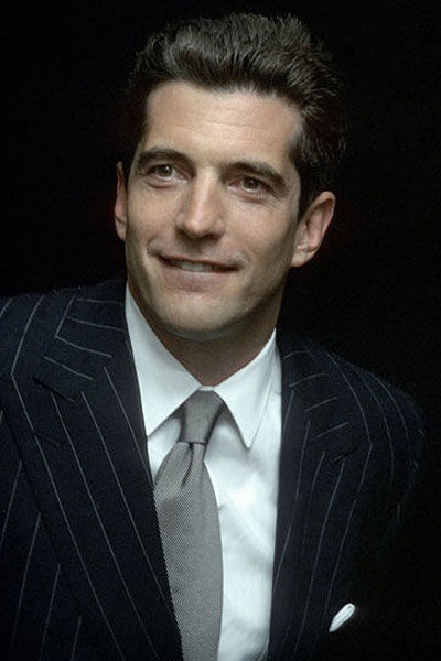 a man in a suit and tie posing for a photo