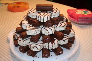 a white plate topped with lots of cake covered in chocolate and marshmallows