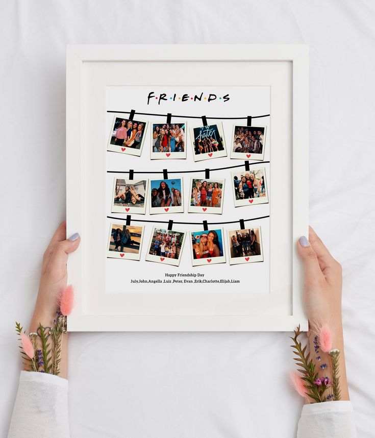 two hands holding up a white frame with photos hanging from clothes pins that say friends