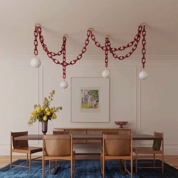 a dining room table with chairs and a blue rug