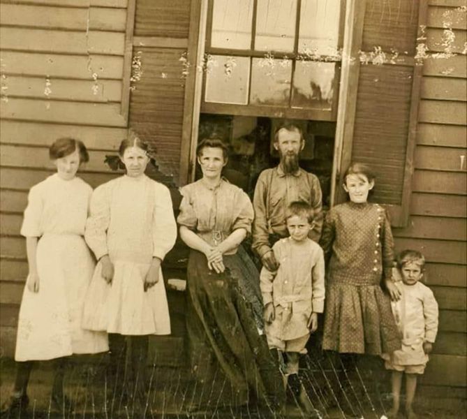 an old black and white photo of a family