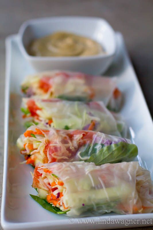 vegetable spring rolls on a plate with dipping sauce in the bowl next to each other