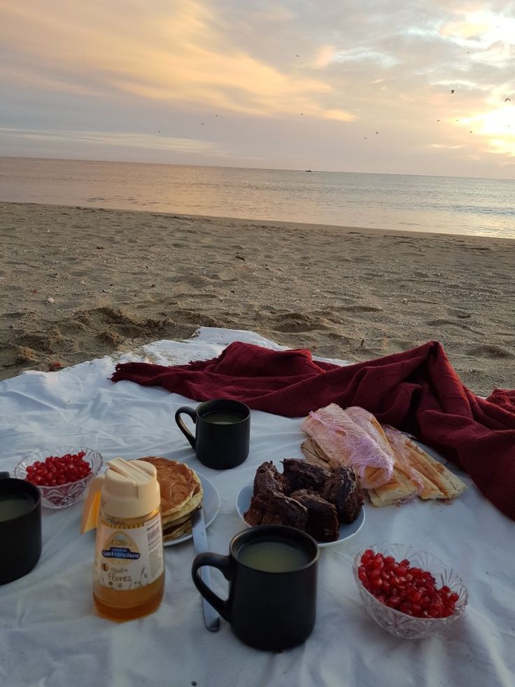 food and drinks on a blanket at the beach