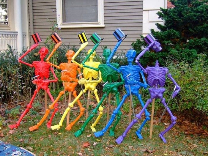 there are many colorful skeleton sculptures in the yard