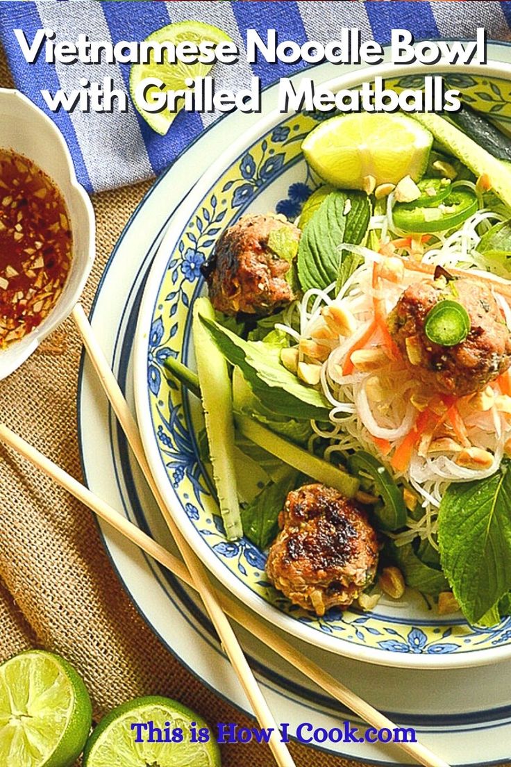 a bowl filled with meatballs and veggies next to some chopsticks