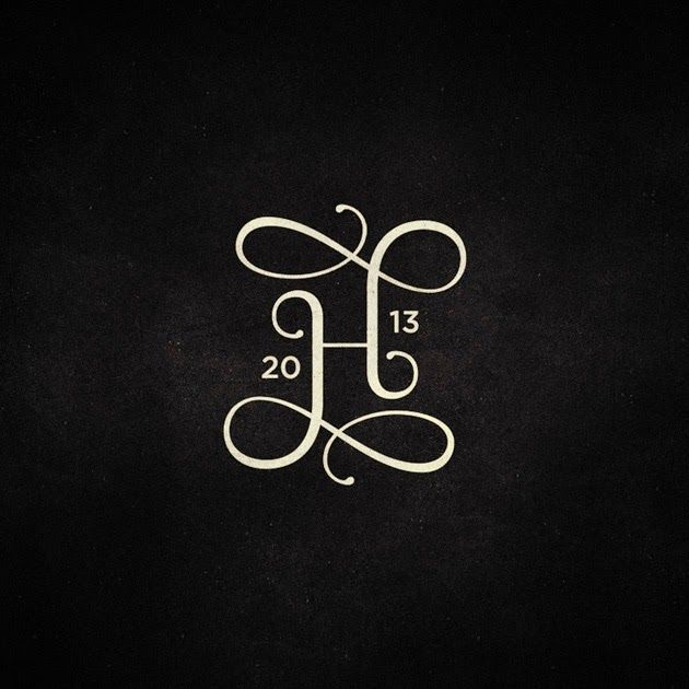 the monogrammed letter h is displayed on a black background