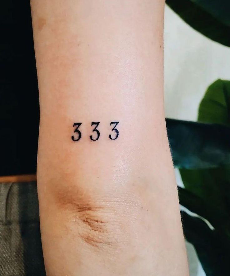 a woman's arm with the number 533 tattooed on it