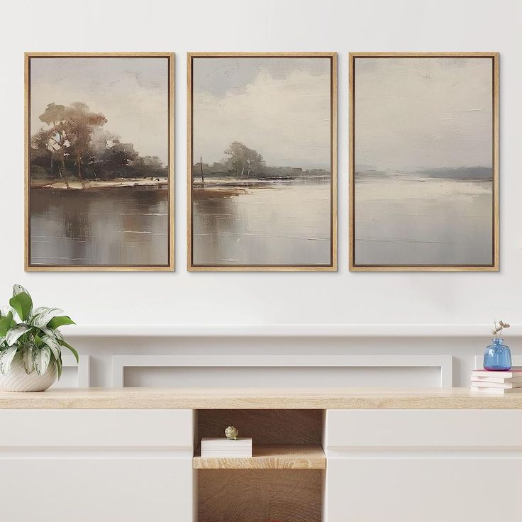 three paintings hanging on the wall above a fireplace