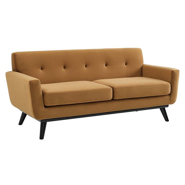 a tan couch with black legs on a white background