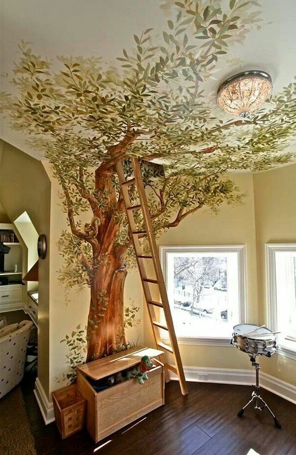 a tree painted on the ceiling in a child's room with a ladder up to it