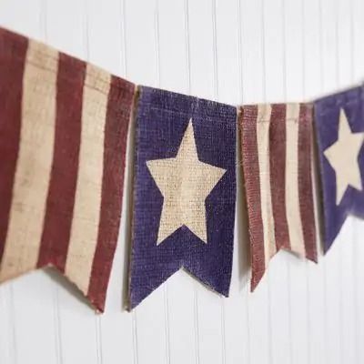 an american flag bunting with stars hanging from it's sides on a white wall