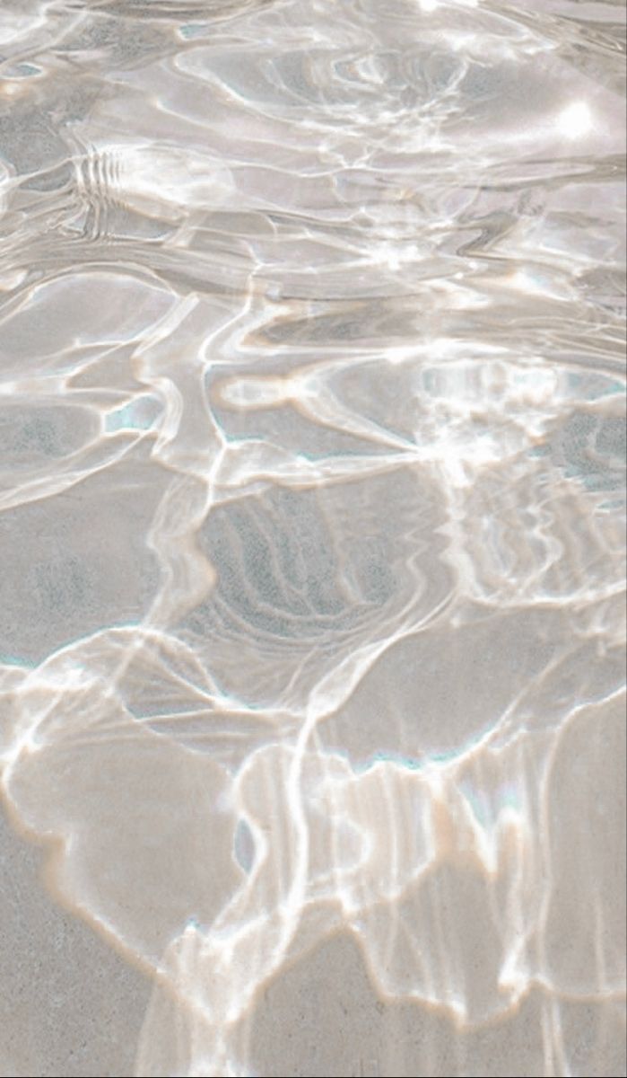 the water is crystal clear and there are ripples on the sand in it's surface