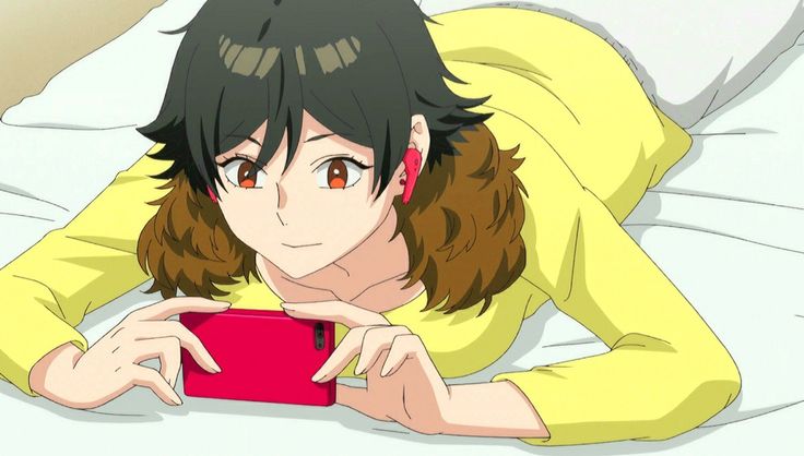 a woman laying on top of a bed next to a red tablet computer in her hand