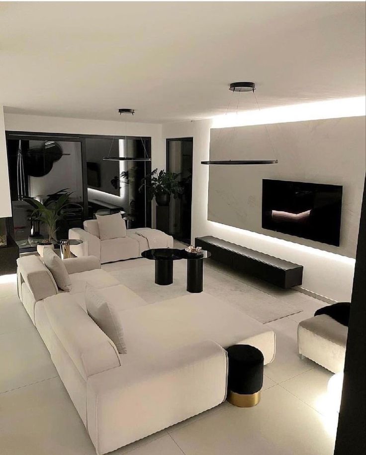 a modern living room with white furniture and black accents