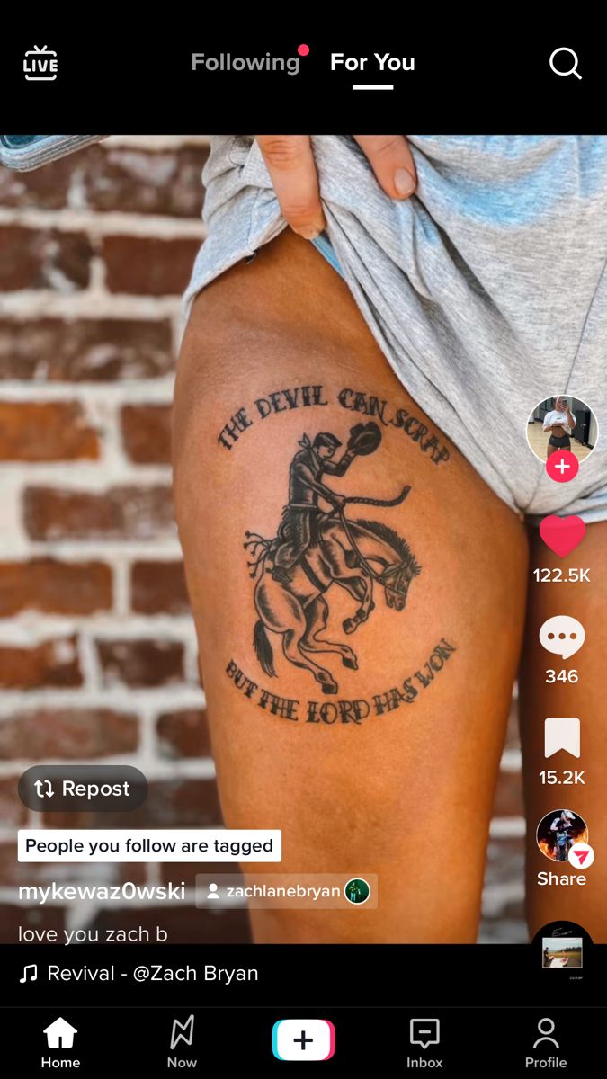 the back of a person's leg with tattoos on it and an image of a horse