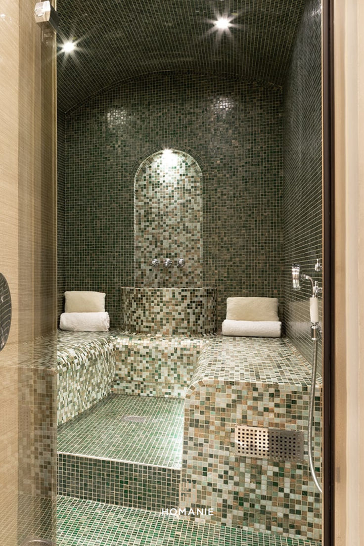 a very nice looking bathroom with green tile