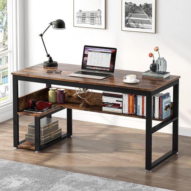 a laptop computer sitting on top of a wooden desk next to a book shelf filled with books